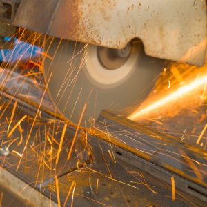 Metalworking. Cutting a metal profile with a circular saw. Natural light